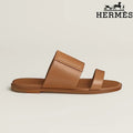 Hermès  female slides Tan Calfskin Two-Strap Flat Slide Sandals